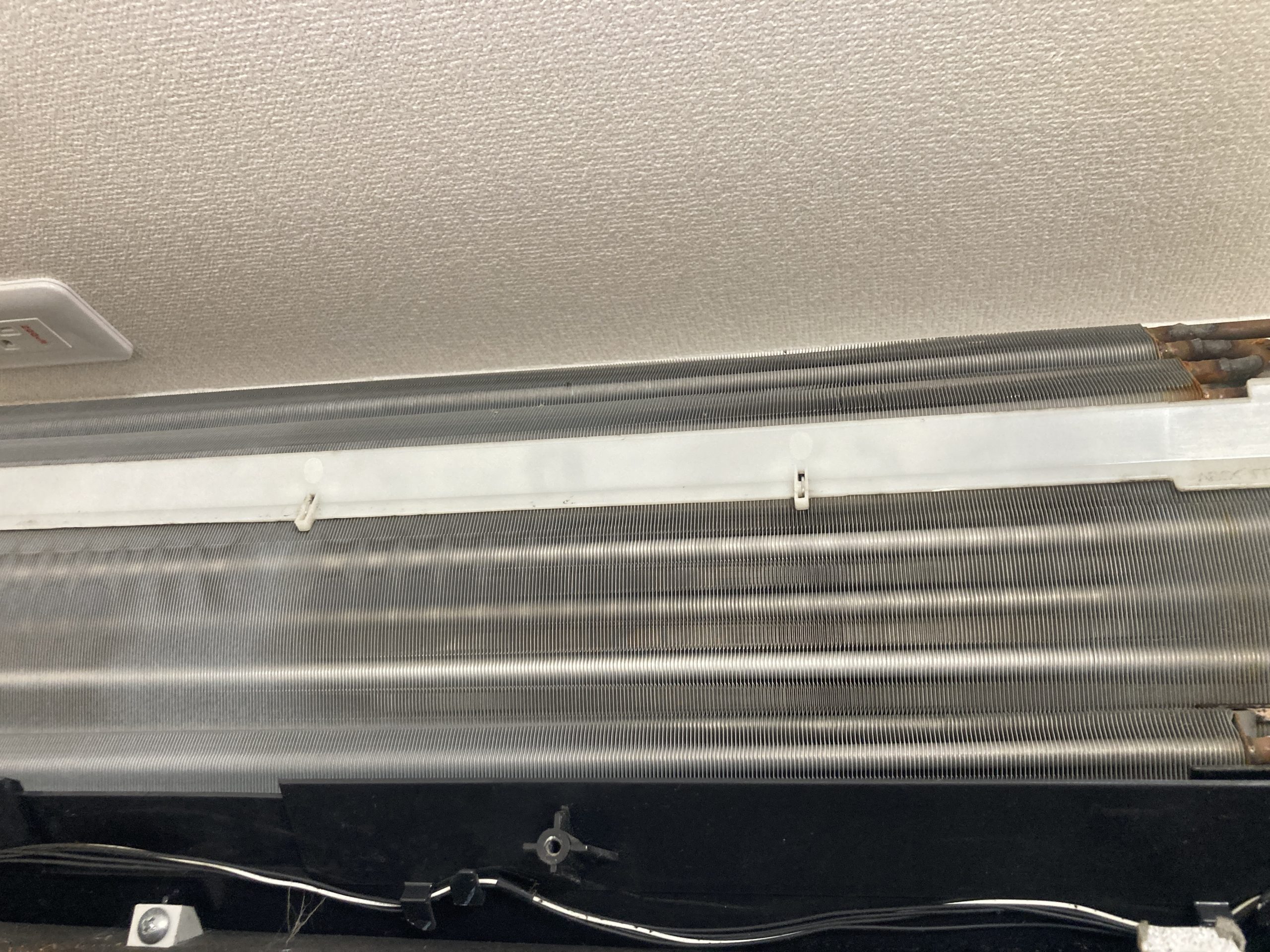 本来は銀色のアルミフィンが、黒く変色するほど汚れが蓄積。風の通り道が塞がれると冷却効率は一気に低下します。