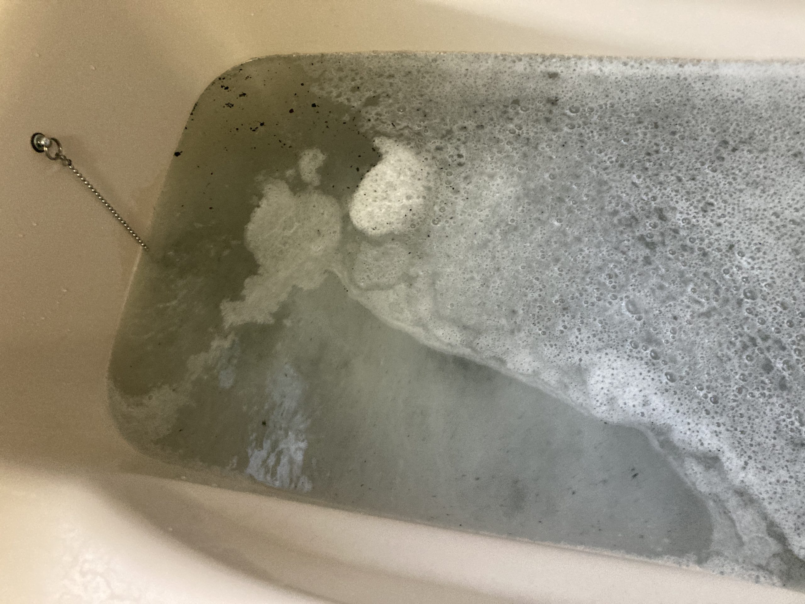 黒いカスや汚れが湯船に浮き始め、 追い焚き配管内部の汚れが少しずつ表に出てきているのが分かります。