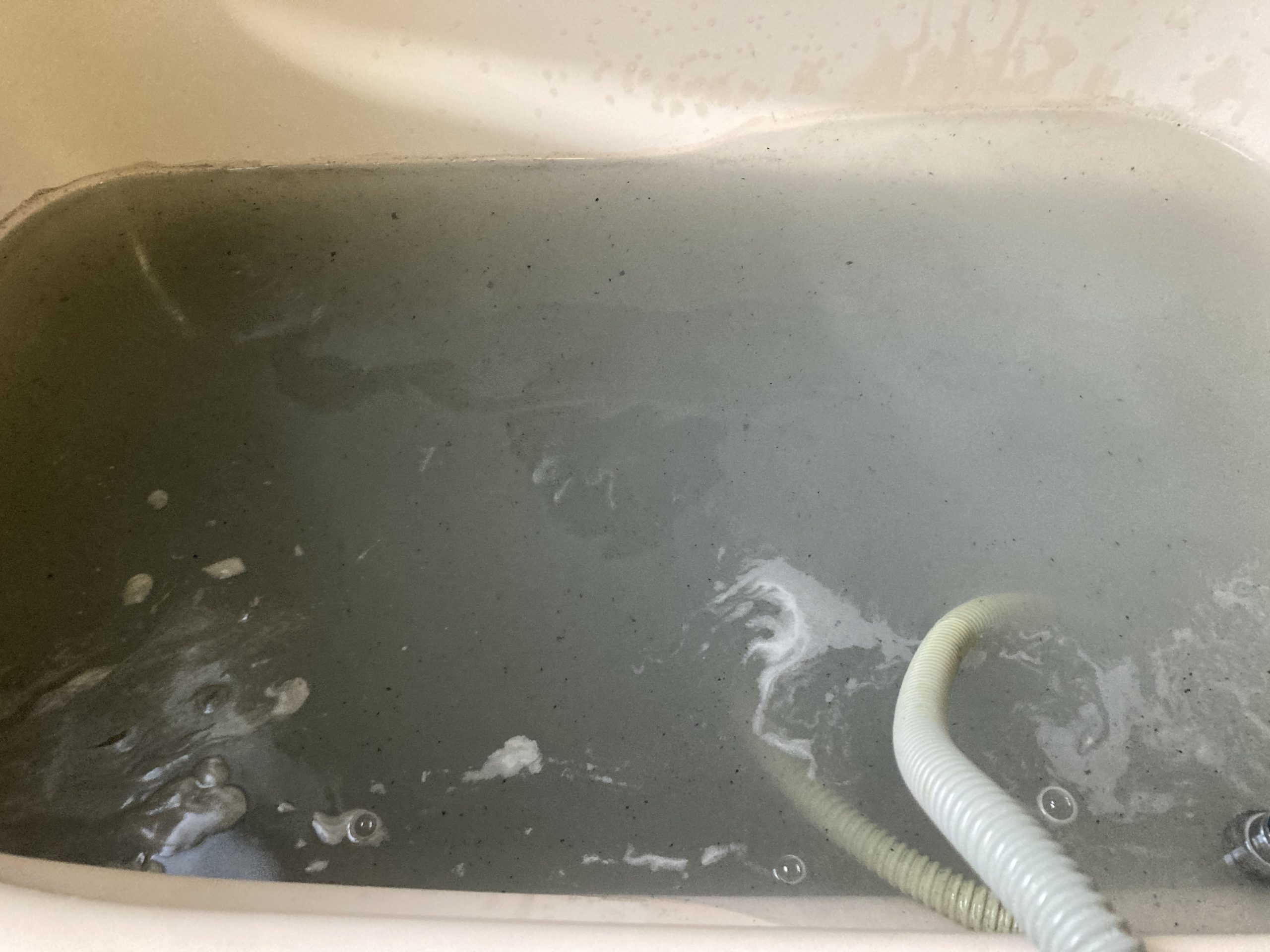 お湯全体がグレー色に変わるほど汚れが排出されました。 エコキュートの自動配管洗浄機能だけでは落としきれない汚れです。